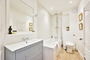 Shower, hair dryer, towels, shampoo
