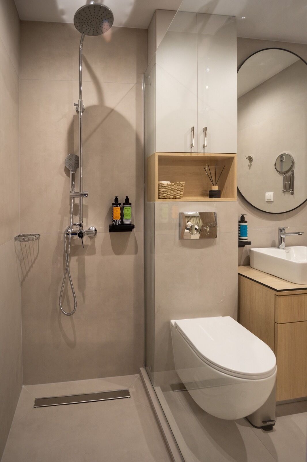 A modern bathroom with a walk-in shower, a toilet, and a sink.