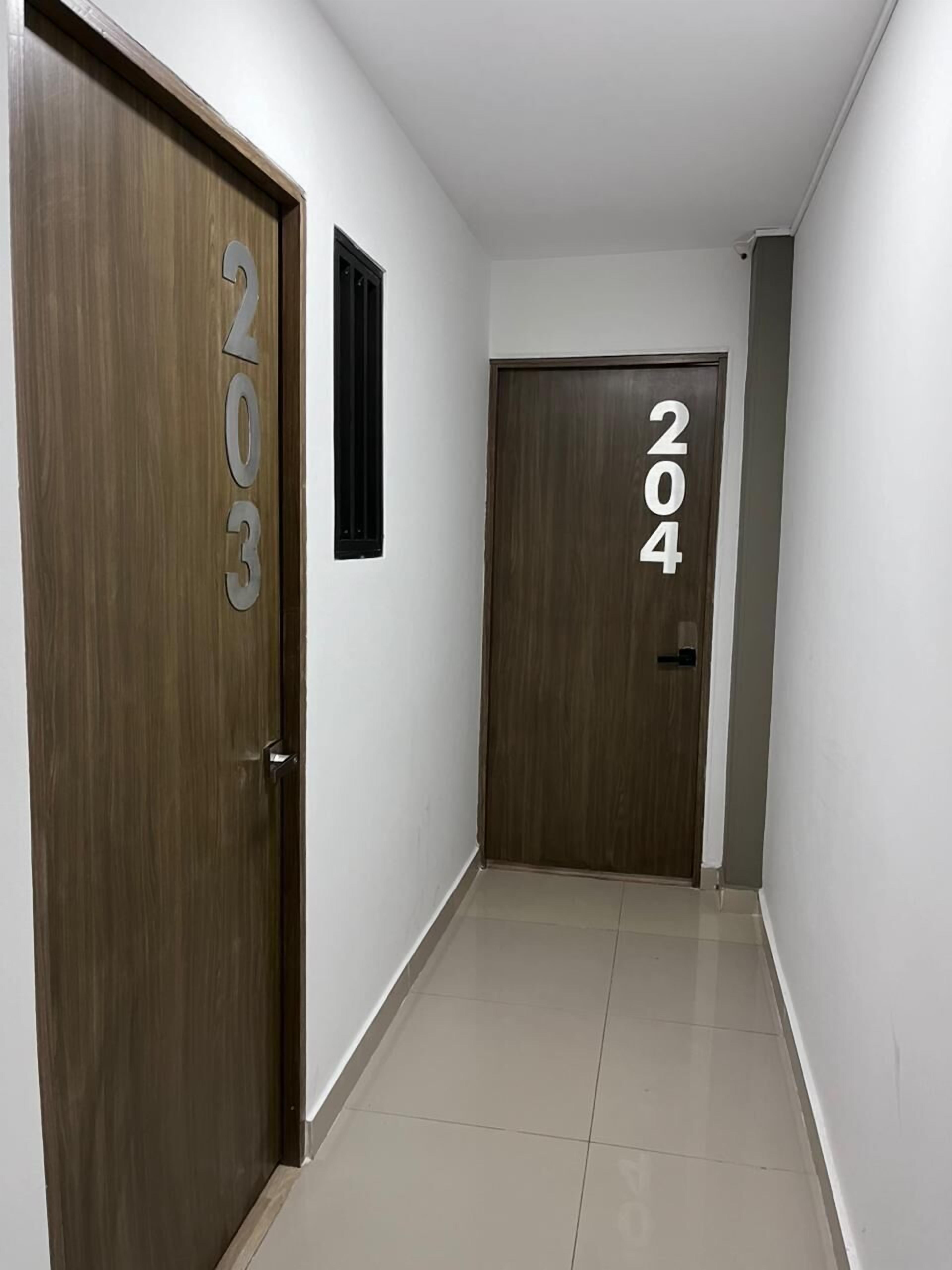 A hallway with two doors, one labeled "203" and the other "204".