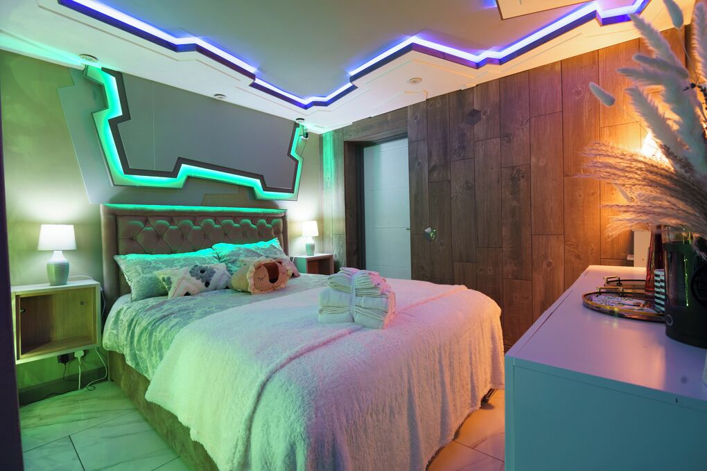 Un dormitorio moderno con cama, mesitas de noche y mesilla.