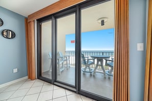 Enjoy the view from the balcony with a table and chairs.