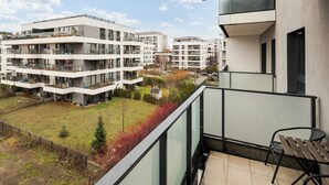 A modern apartment building with multiple balconies and a view of a residential area. - Racjonalizacji Stylish Apartment (Warszawa)