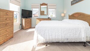 A bedroom with a bed, a television, a dresser, and a mirror. - Top Floor Deck w/ Ocean View | Beach Block House (Cape May)