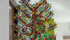 A colorful tree sculpture with figures on branches and a group of figures at the base. - Casa 53 Marichuy Mexican Style with private pool! (Cancún)