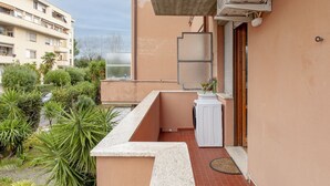 A small balcony with a washing machine, a window, and a concrete structure. - Homiday - Hospital/Airport- A/C and Free Parking (Pisa)