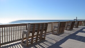 A wooden boardwalk leading to a beach with a clear sky. - Sea Oaks 103 - Oceanfront Complex in Garden City Beach (Garden City Beach)