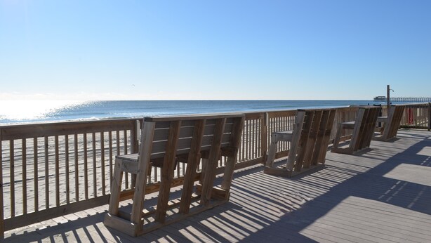 A wooden boardwalk leading to a beach with a clear sky. - Sea Oaks 102 - Oceanfront Complex in Garden City Beach (Garden City Beach)