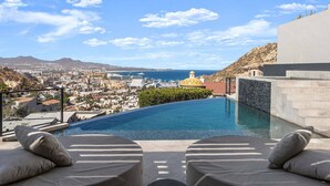 A poolside view with a clear view of the city and ocean. - Brand-New Villa with Full Staff, 2 Pools, & Close to Downtown Cabo (Cabo San Lucas)