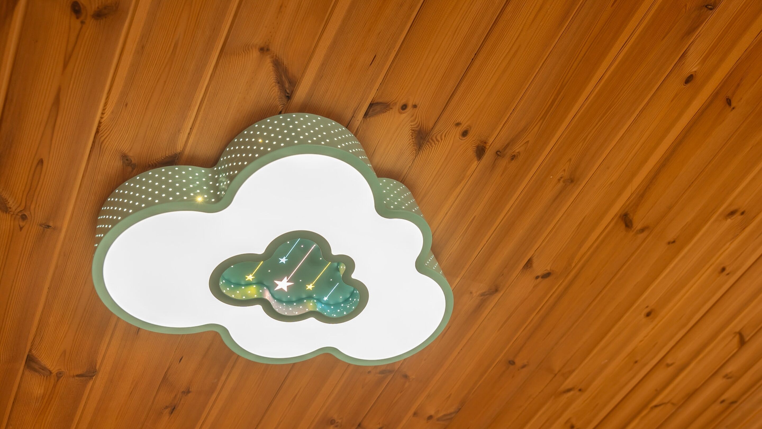 A ceiling with a decorative cloud-shaped light fixture.