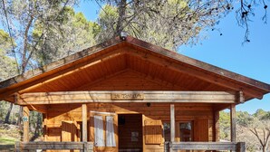 A wooden cabin with a sign reading 'La Tovilla' and a number '56' on the door.