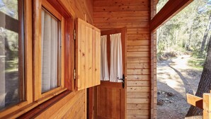 A wooden cabin with a door leading to an outdoor path.