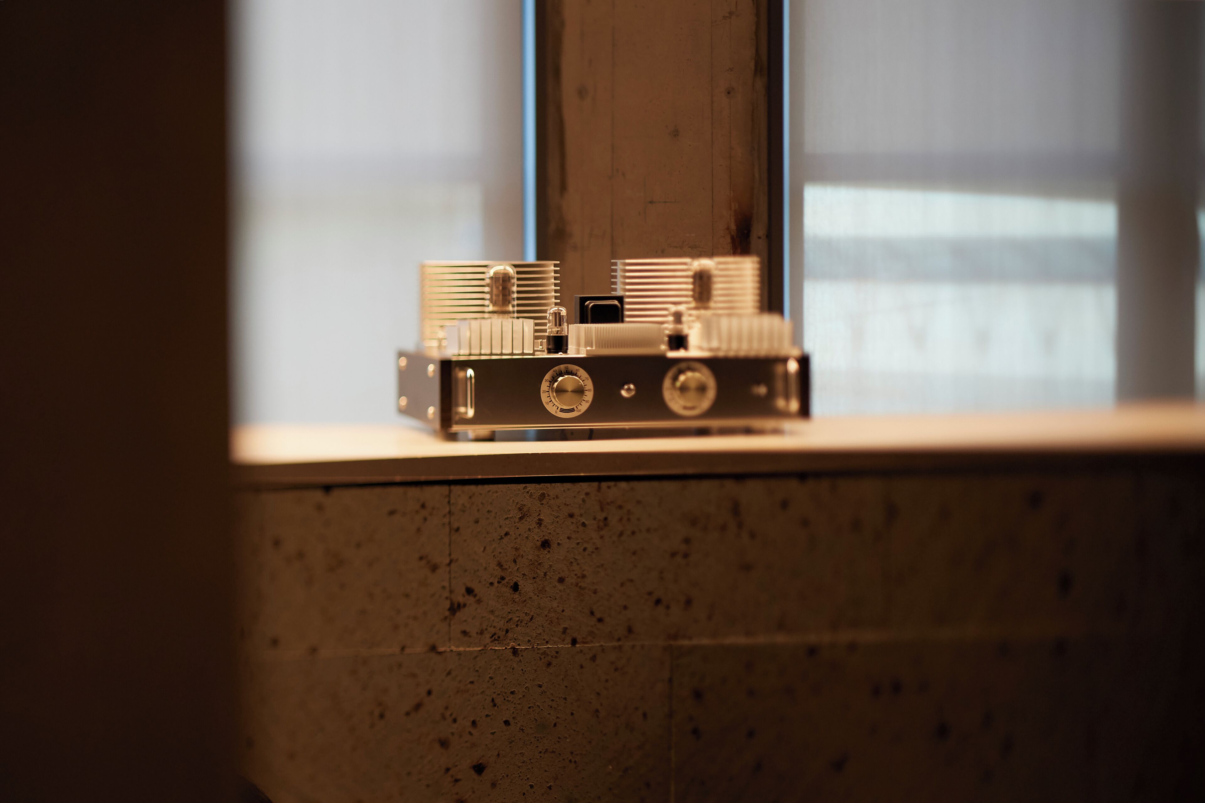 A vintage camera on a windowsill.