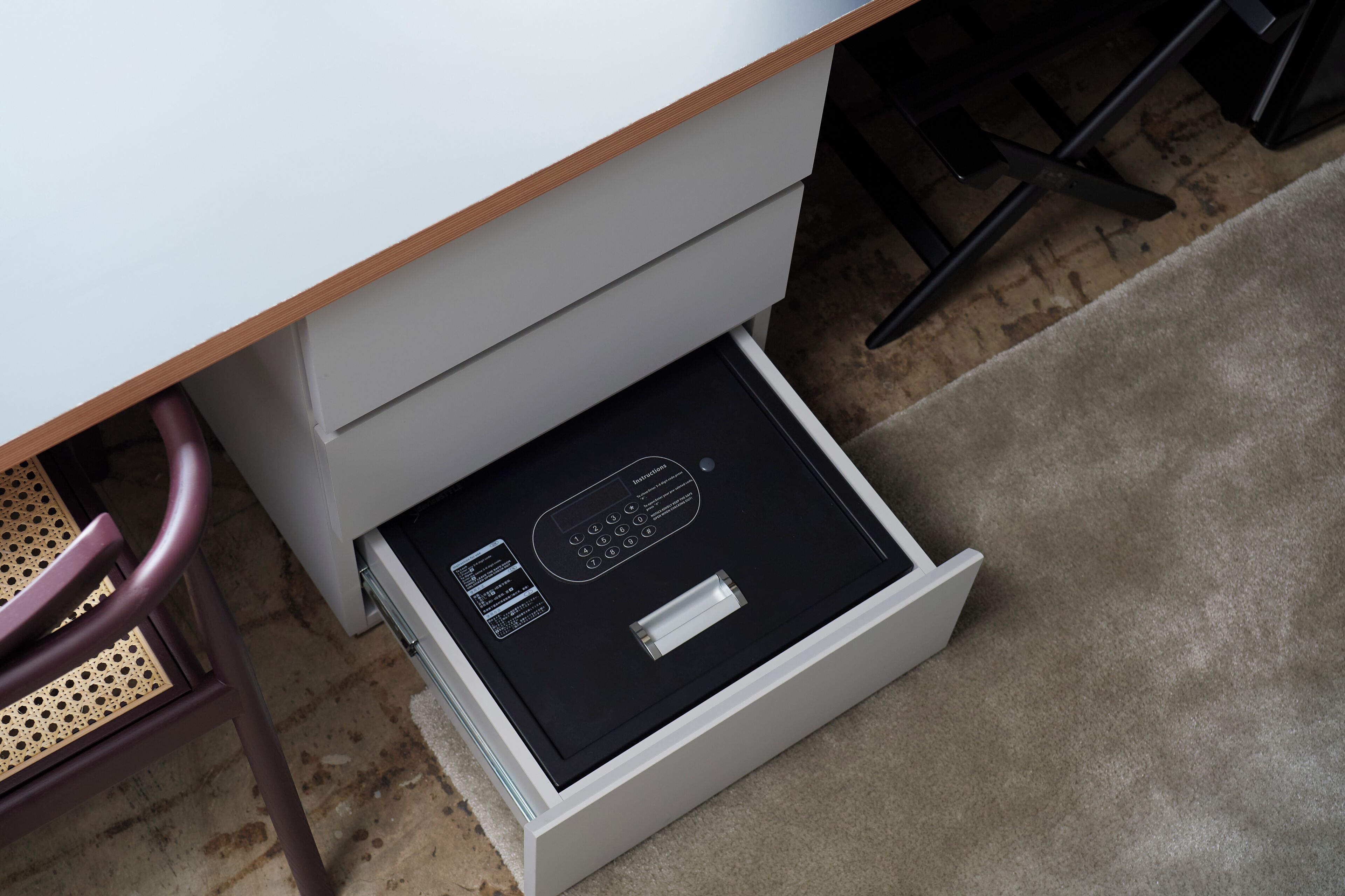 A white drawer with a black interior, a control panel, and a metallic handle.