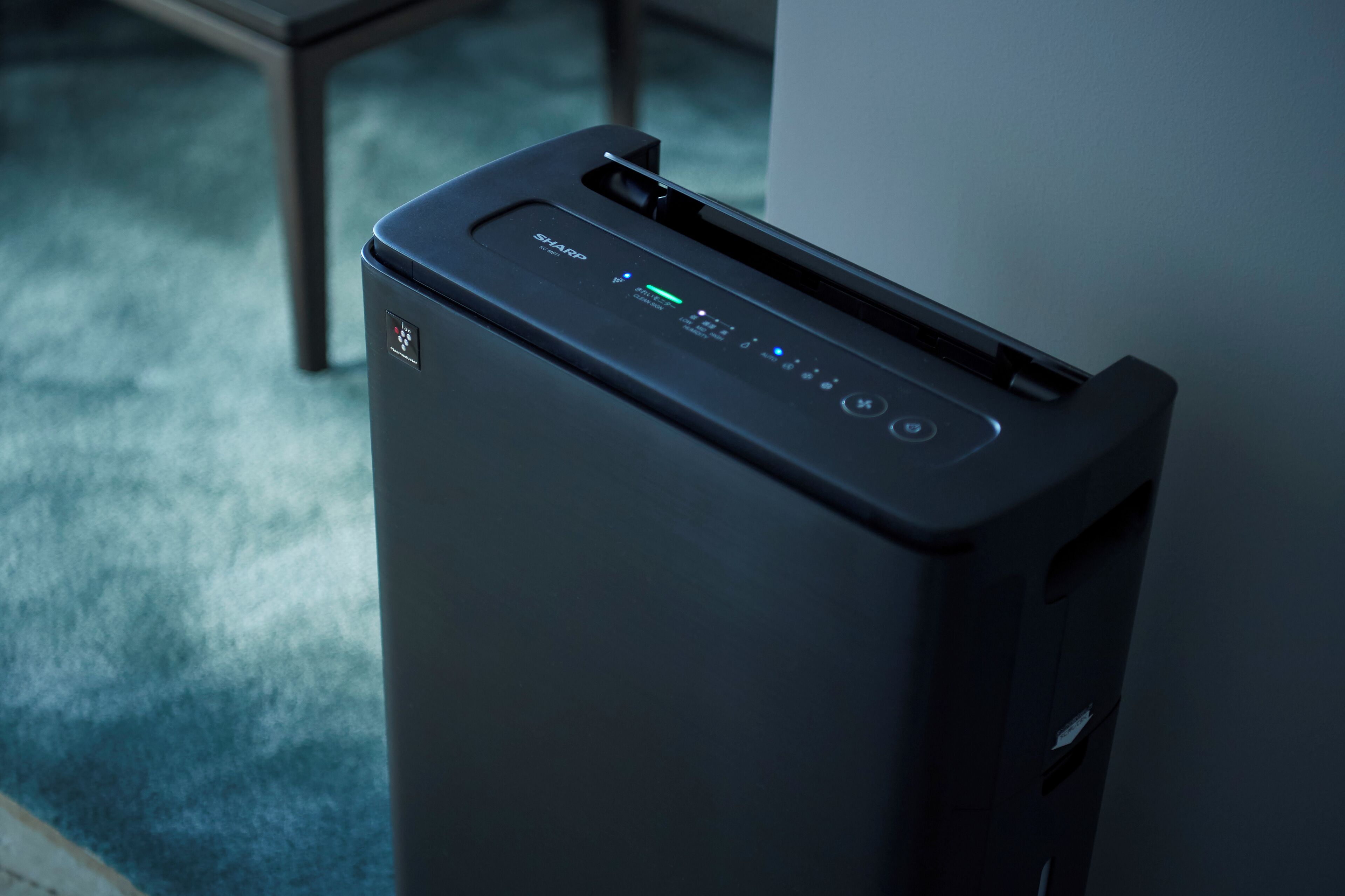 A black printer with a control panel and a paper tray.