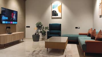 Deluxe Apartment, City View | Living area | TV