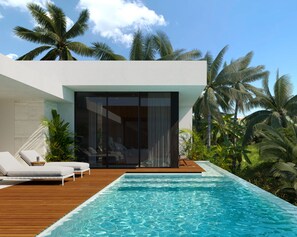 A modern poolside area with a clear pool, wooden deck, and lounge chairs. - Green Flow Villa 12 - 3 Bedrooms (Ubud)