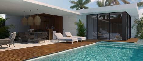 Una piscina al aire libre, tumbonas