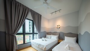 A hotel room with two beds, a ceiling fan, a view of a construction site, and a wall-mounted light fixture. - Maya Bay Residences (Banting)