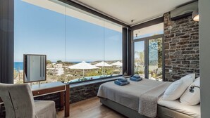 A bedroom with a large window, a bed, a desk, and a chair. - Villa Kera Panorama - villa with pool, Crete (Vámos)