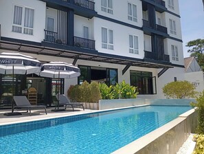 Piscine extérieure, parasols de plage, chaises longues