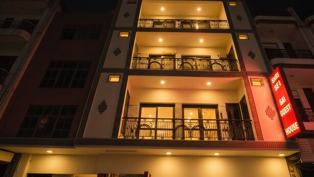 A multi-story building with balconies and a sign indicating it is a guest house. - Shri Sai Guest House - Opp Azadpur Main Mandi (New Delhi)