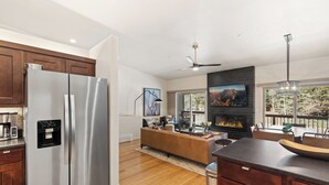 A modern kitchen with stainless steel appliances, a built-in water dispenser, and a large island with seating.