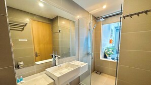 A modern bathroom with two sinks, a large mirror, and a glass-enclosed shower. - Corgi House Homestay Nha Trang (Nha Trang)