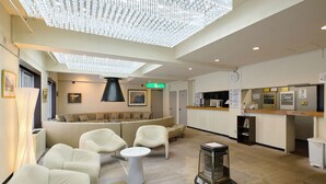 A hotel lobby with a seating area, a reception desk, and a large chandelier. - HOTEL ST.MORITZ (Yuzawa)