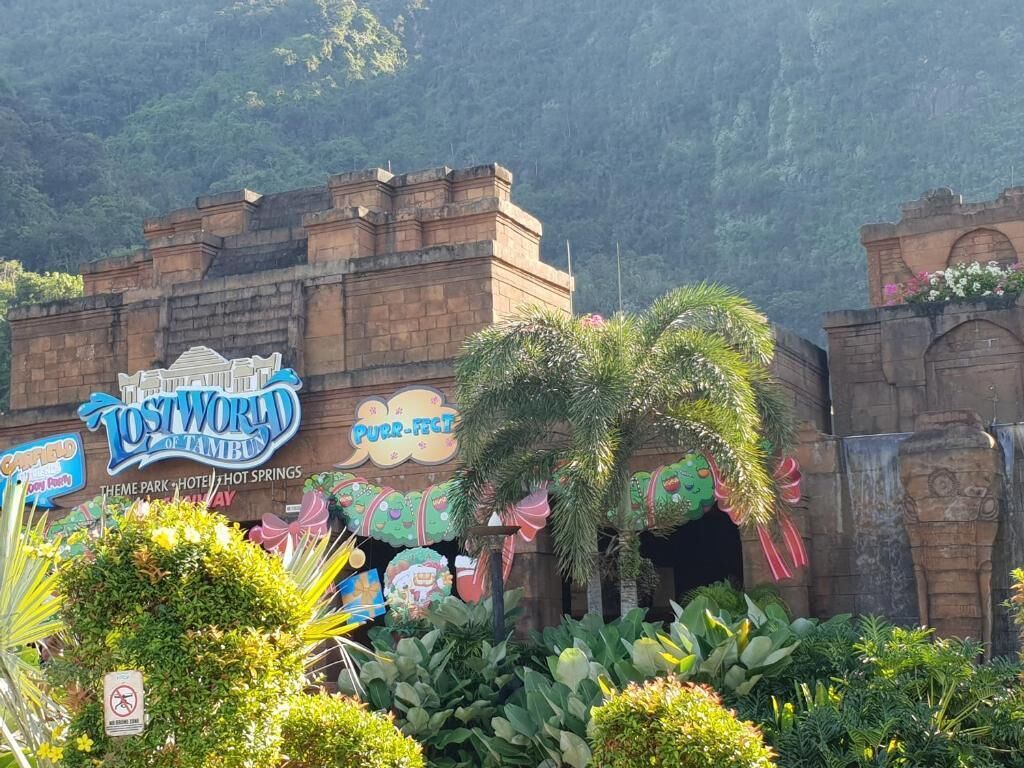 A theme park entrance with a sign for 'Lost World of Tambun' and 'RR-FACT'.