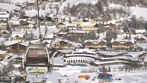 Ein Skigebiet mit Chalets, einer Seilbahn und einem Poolbereich.
