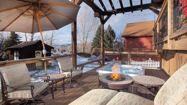 A wooden deck with outdoor seating, a fire pit, and a hot tub. - Escape to Modern Mountain Retreat Near Top Ski Resorts w/ Hot Tub! (Gypsum)