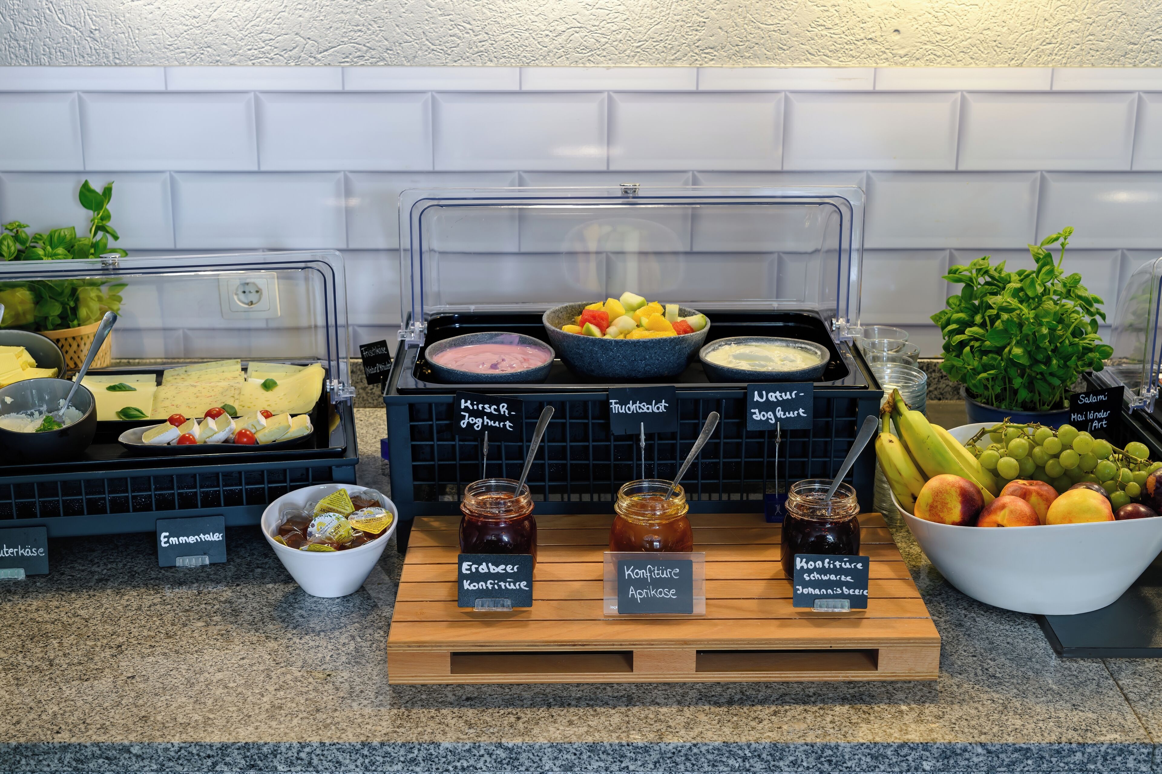 A buffet with various food items and condiments.