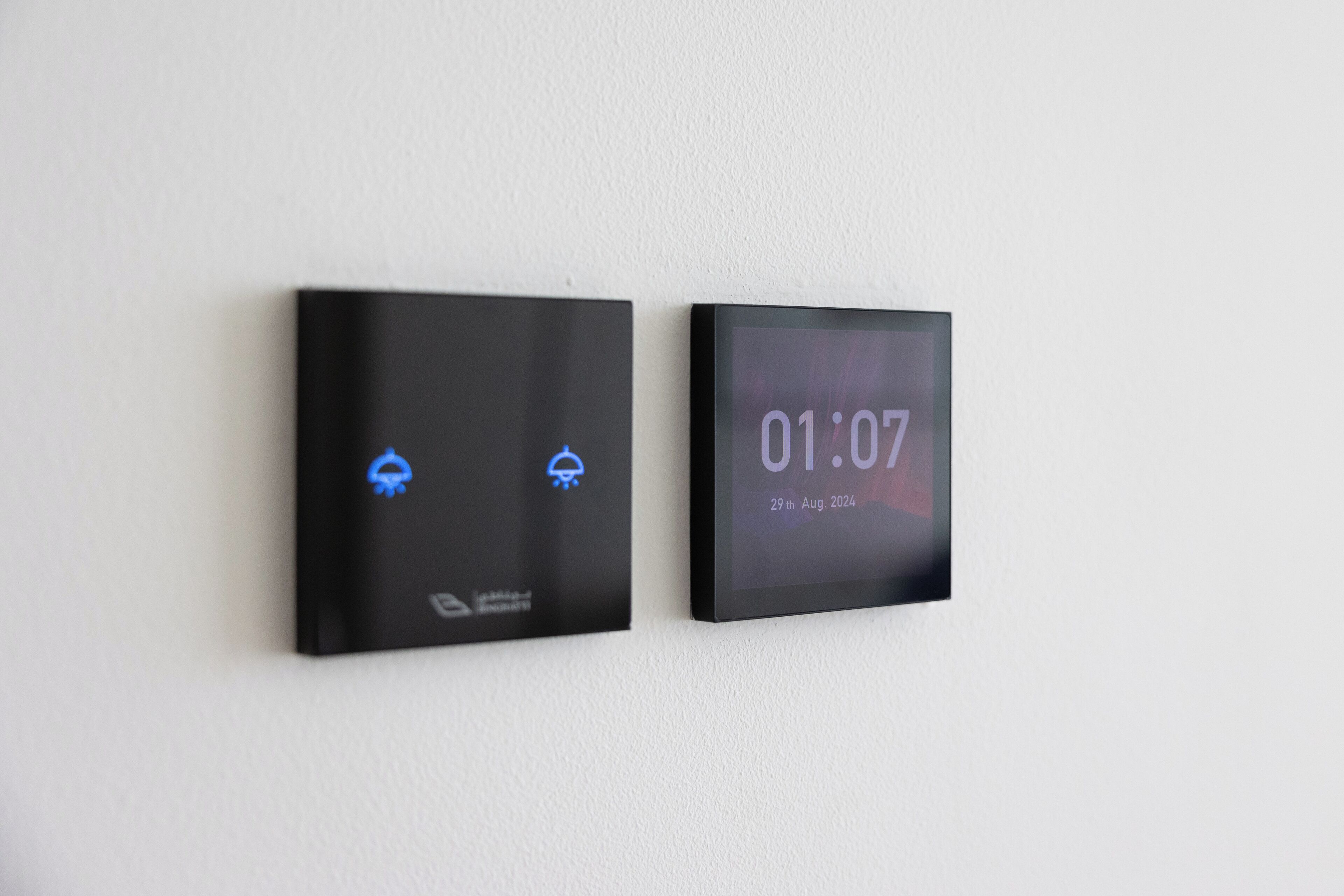 Two digital clocks on a wall displaying the time and date.