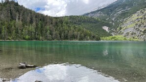 A clear lake surrounded by forested mountains. - Lavish apartment with sauna in Tyrol (Lermoos)