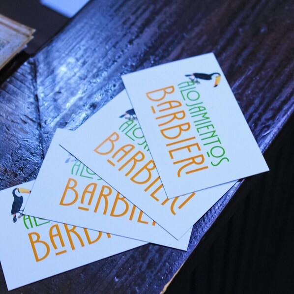 A wooden surface with several white cards with text and a small bird illustration.
