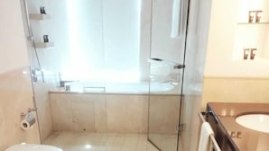 A modern bathroom with a glass shower enclosure, a toilet, a bidet, and a sink. - Luxury Address Res Dubai Marina 1BR-2514 (Dubai)