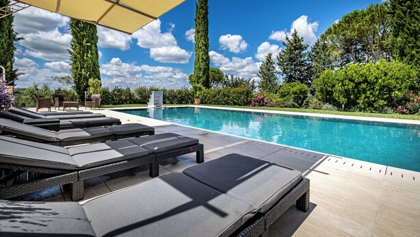 A poolside area with lounge chairs and a pergola. - Bagno a Ripoli, Italy. Entire accommodation: villa (Toscana)