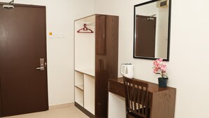 A room with a desk, chair, wardrobe, and a mirror. - De Royal Hotel (Ampang)