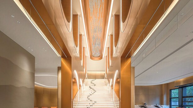 A modern interior with a central staircase, seating areas, and a large window providing natural light. - MUSTEL  ARTE  HOTEL  ZHENLIN  CHENGDU (Chengdu)