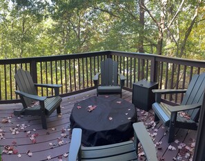 A covered deck with Adirondack chairs, a table, and a grill. - Welcome To "Snowed Inn” - Walk On And Off The Slopes (McGaheysville)