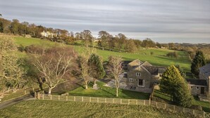 A large stone house with a paved driveway and a wooden fence. - The Dog Kennels, Leyburn (Leyburn)
