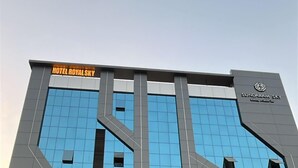A modern hotel building with a glass facade, named 'Hotel Royal Sky' and 'Sundaram Sky'. - Hotel Royal SKY (Morbi)