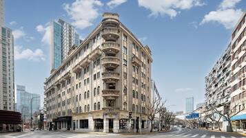 A multi-story building with a classic architectural style, featuring balconies and large windows.