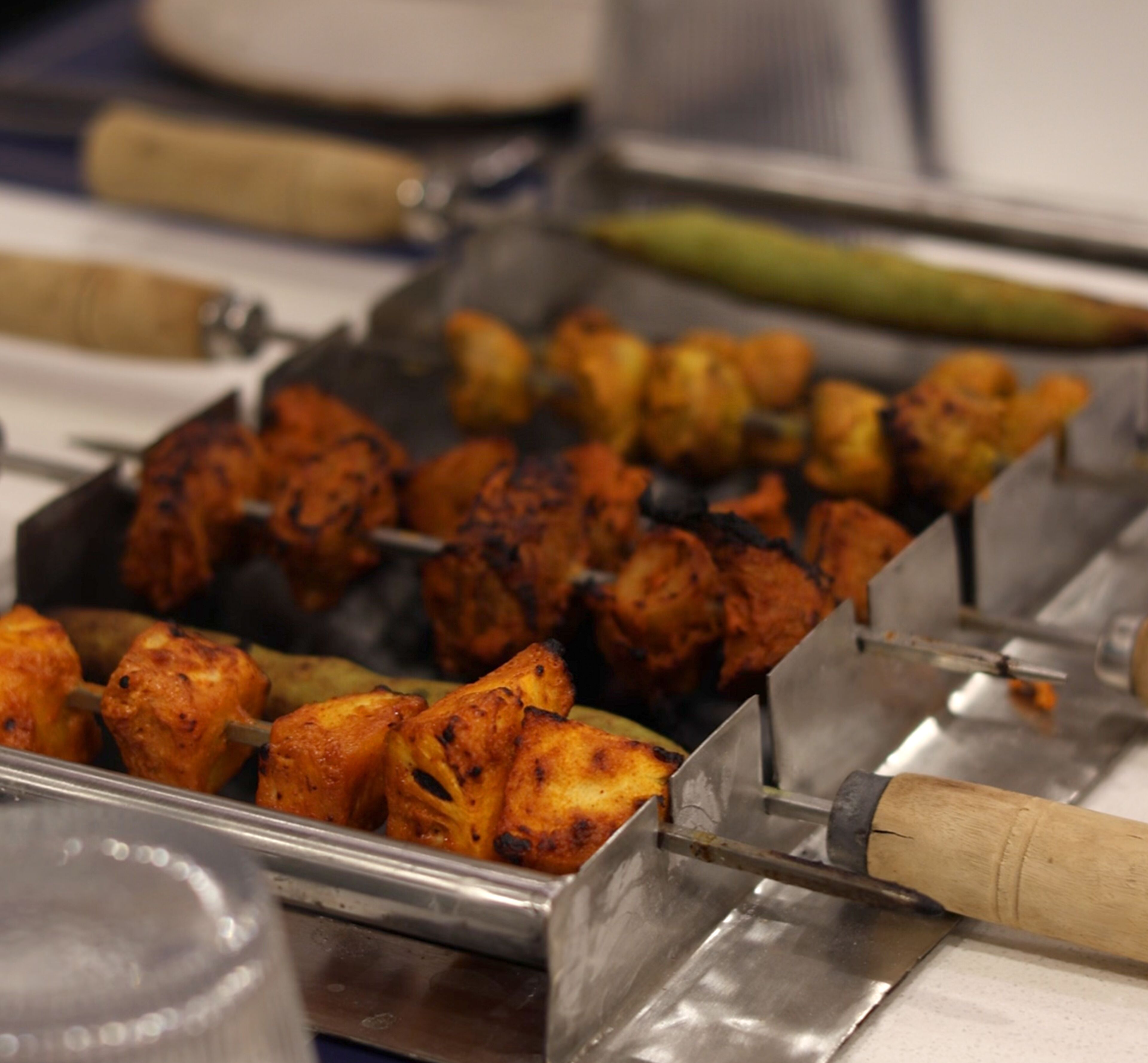 A variety of grilled skewers on a tray.