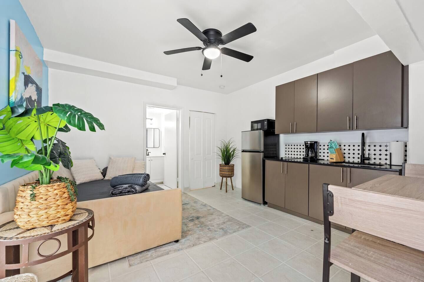A modern apartment with a living room, kitchen, and dining area.