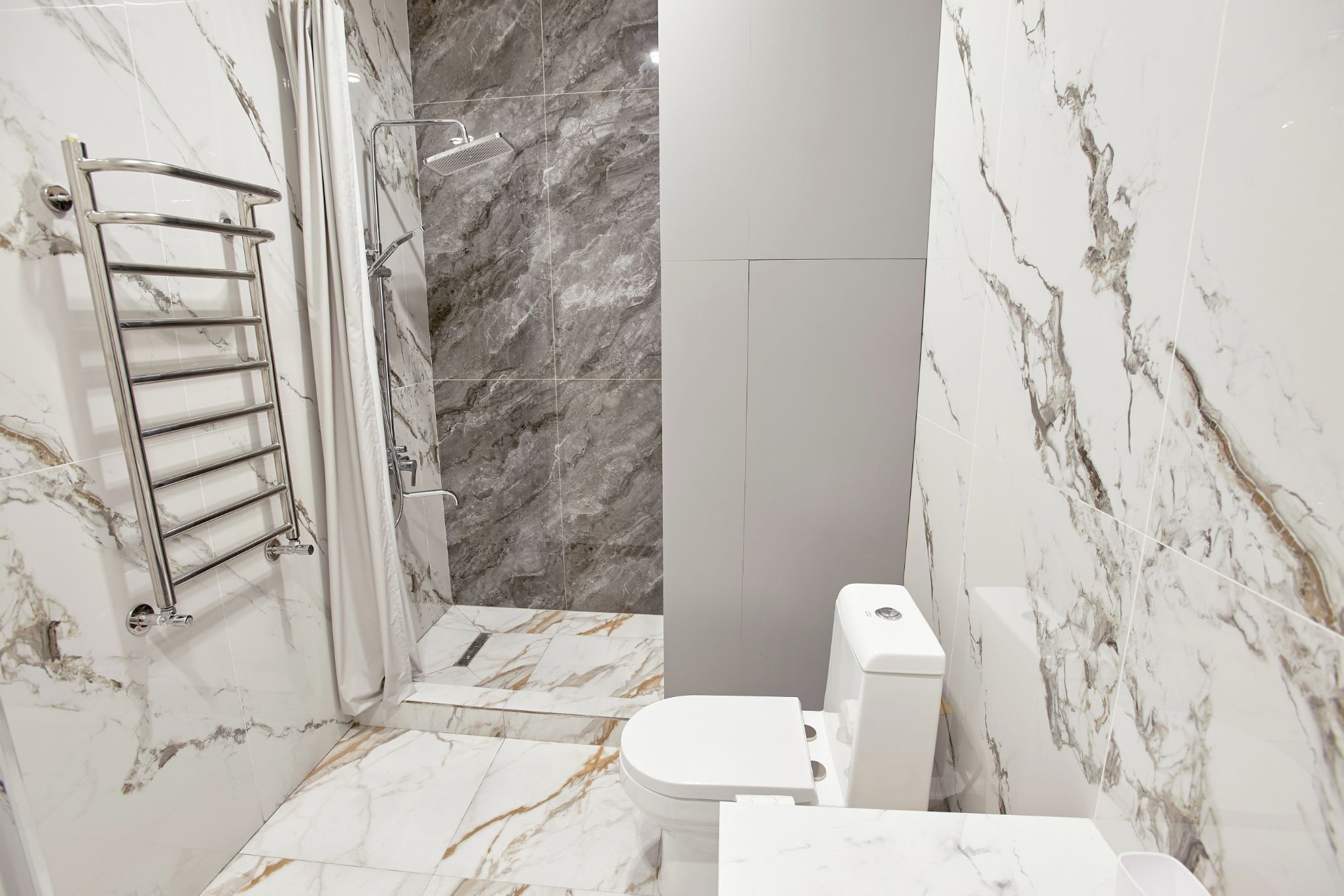 Ein Badezimmer mit Toilette, Dusche und Handtuchhalter.