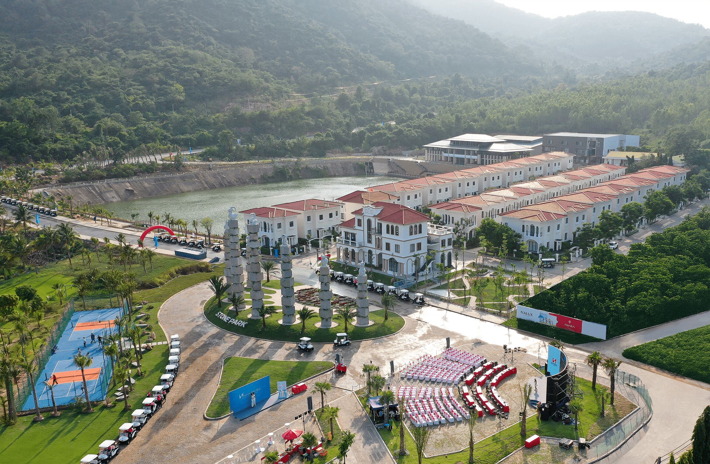 A hotel with multiple buildings, a sports court, and a parking area.