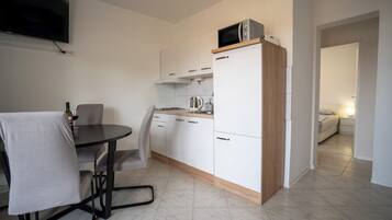 Comfort Apartment, Balcony, Garden View | Private kitchen | Full-size fridge, microwave, coffee/tea maker, electric kettle