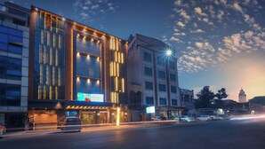 A modern hotel with a prominent entrance, large windows, and a well-lit facade. - Nest By TreeHouse Stamp Amritsar (Amritsar)
