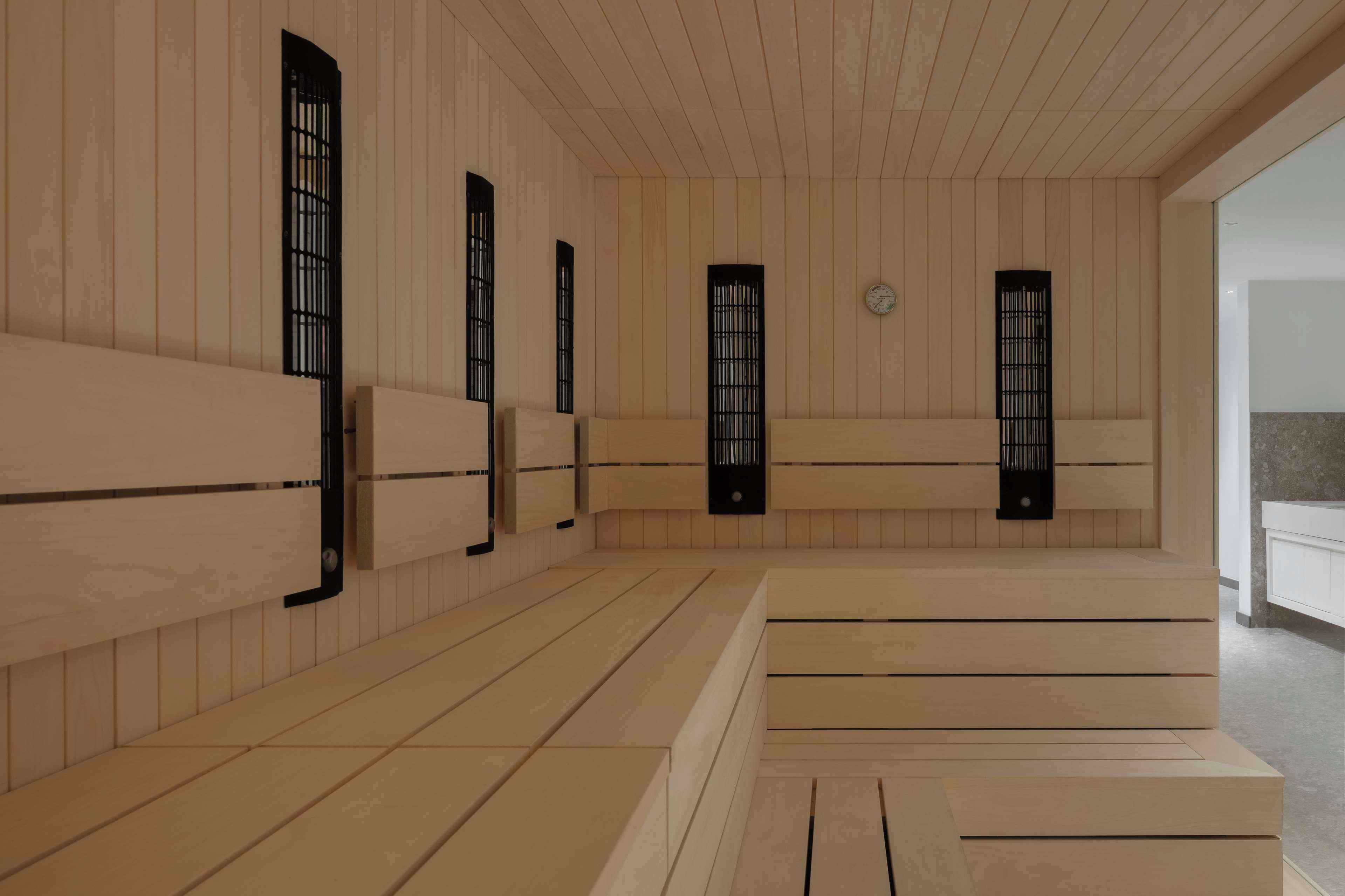 A room with wooden panel walls, black-framed windows, and a tiled floor.